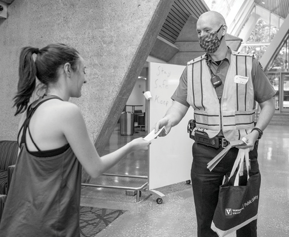 cso officer hands student mask