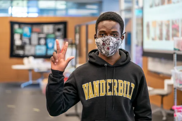 Students show their new masks.