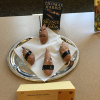 Yams with eyes and tape over where a mouth would be below the eyes.