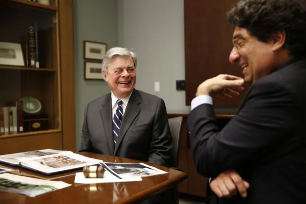 Jim Sasser and former Chancellor Nicholas Zeppos look through Sasser's papers as he donates them to the Vanderbilt Library in 2013. (John Russell/Vanderbilt)