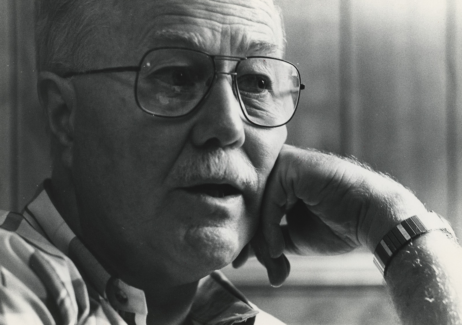 Close-up shot of Dean Joseph C. Hough, with his hand resting on his cheek. Black and white shot.