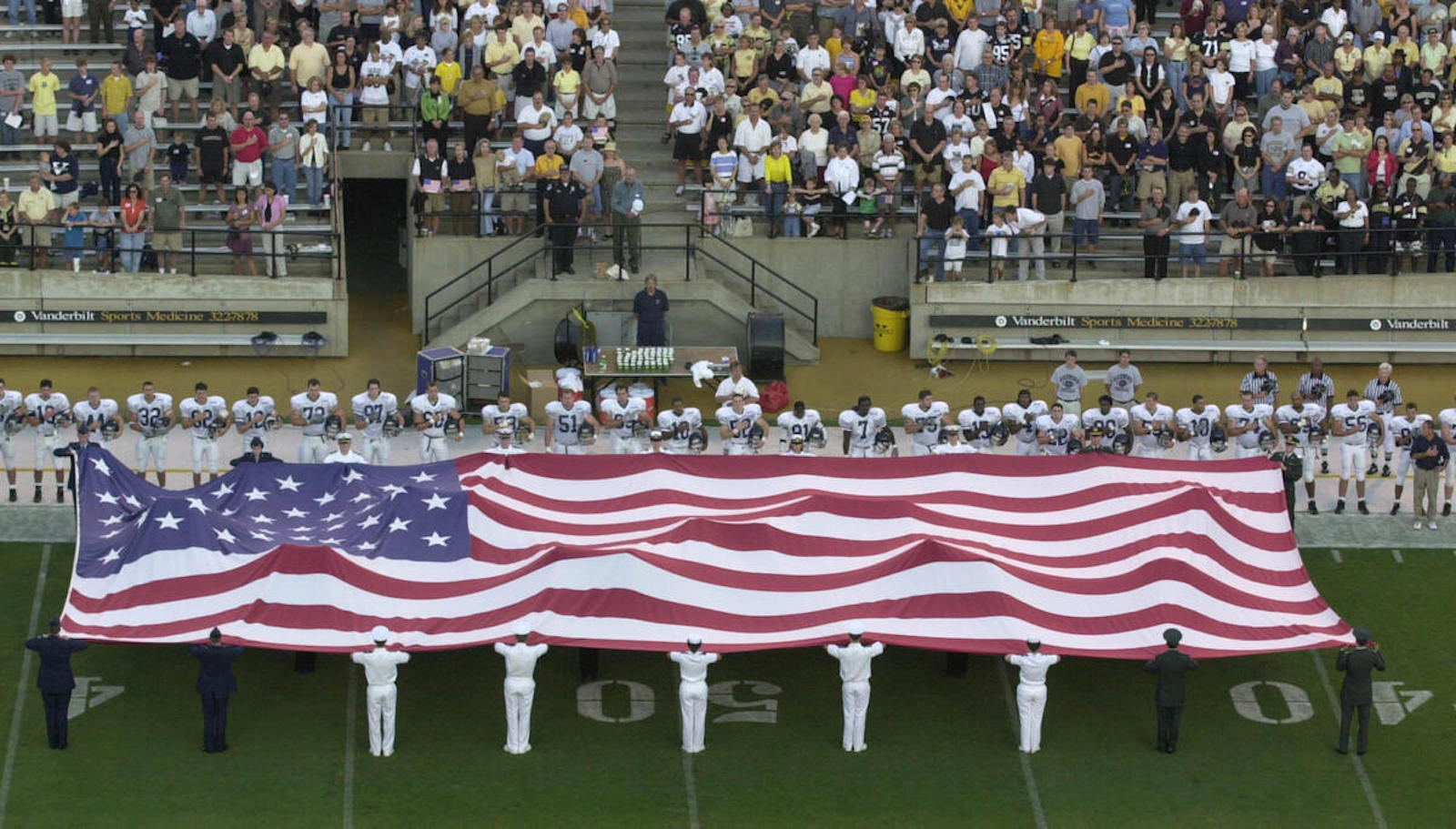 U.S. flag held by military members on Vanderbilt football field