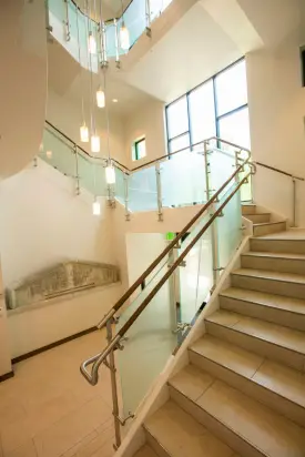 Alumni may recall the tradition of graduating students taking photographs by a stone pediment engraved with the Latin term “schola prophetarum,” or “school of prophets.” That architectural piece was salvaged and is prominently featured in the main stairwell of the building addition. (Anne Rayner/Vanderbilt)