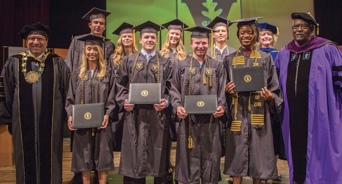 photo of Chancellor Zeppos and David Williams with graduating student-athletes