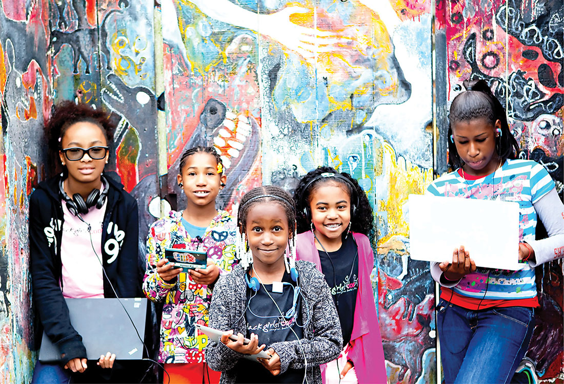 Photo of young African American girls with computers