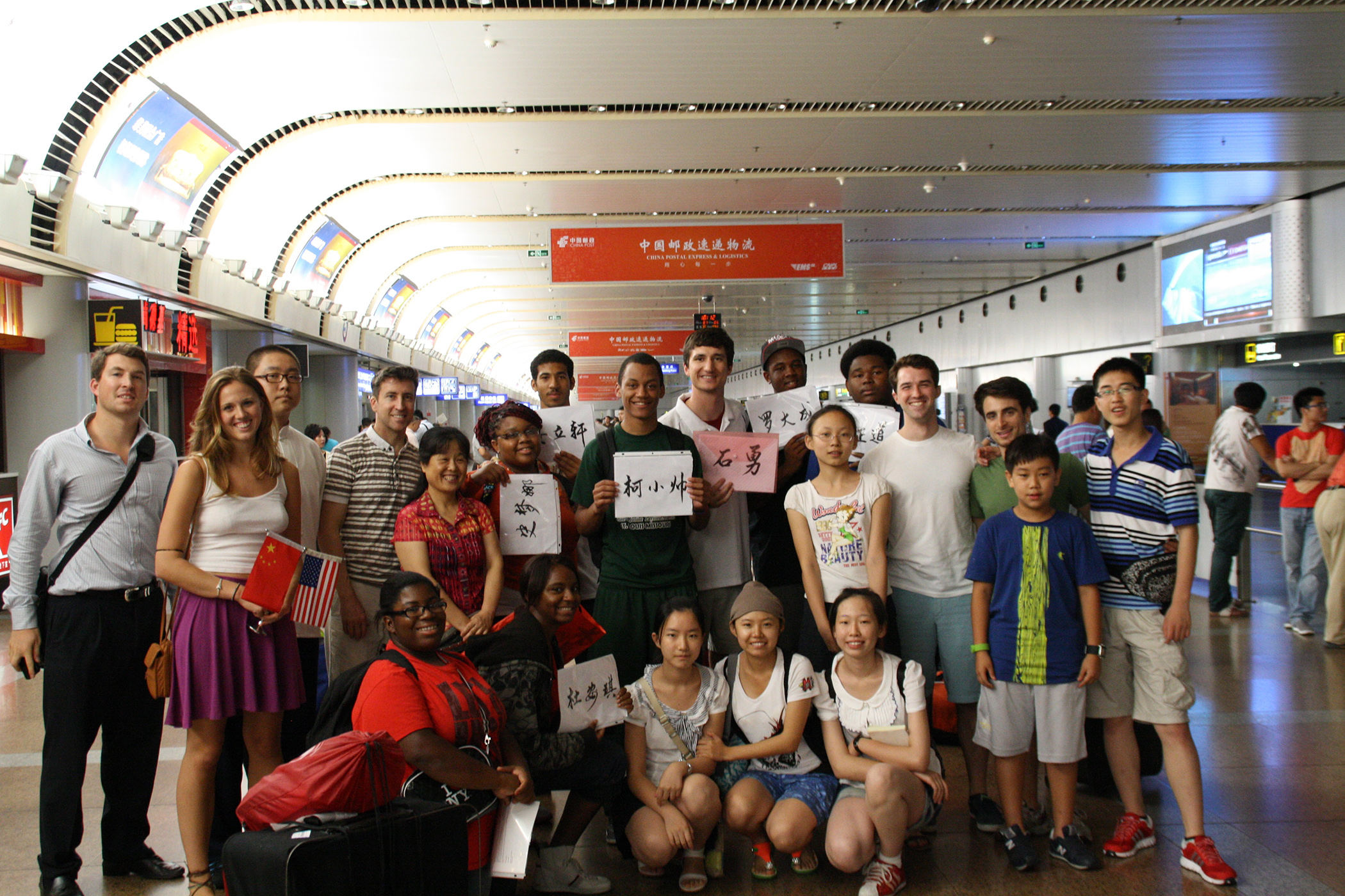 Students from Birmingham, Ala., arrive at the Beijing airport during the summer of 2012. Wyatt Smith is in the middle of the back row holding the pink sign. (Courtesy of Wyatt Smith)