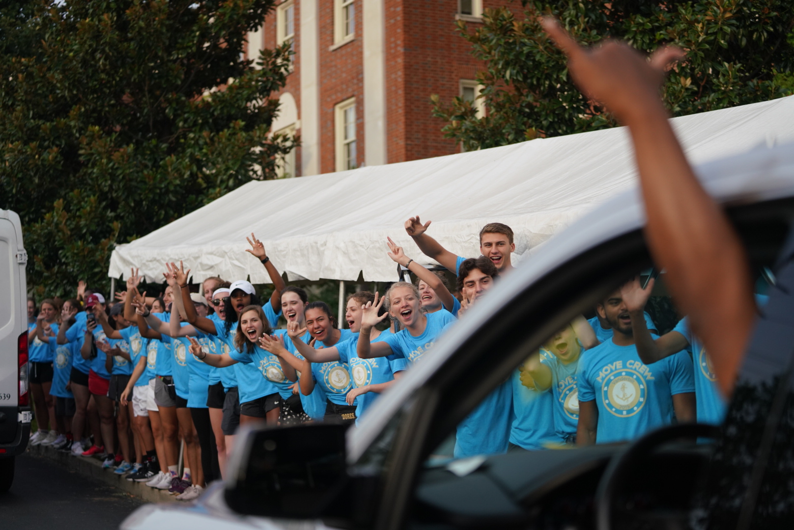 Students standing and cheering for new VU students.
