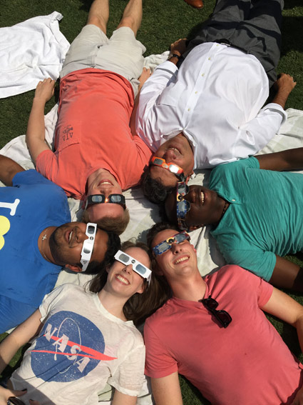 Alexandra Doten (bottom left) and friends watch the total solar eclipse on campus with Chancellor Nicholas S. Zeppos (top right) on August 21, 2017. 