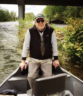 photograph of Vereen Bell in boat near bridge on St. Marks River