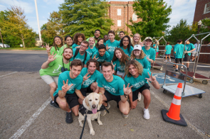 The Move Crew pose for a picture with Officer Jack during Move-In 2022..