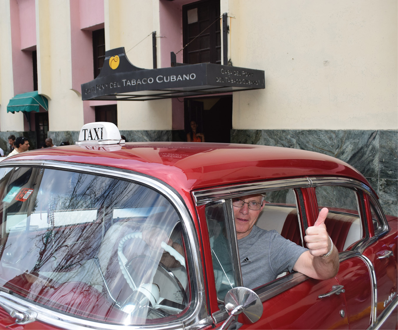 Clair Cramer enjoys a classic car during his Vanderbilt Travel Program trip to Havana, Cuba.
