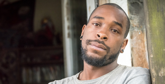 serious young black man standing outside