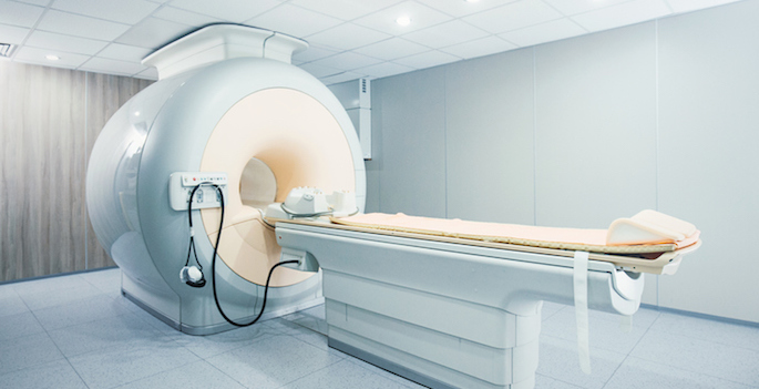 Closeup of a state of the art MRI scanner at a hospital with retractable bed.