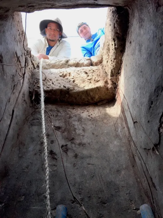 Vanderbilt students Niall Alvarado and Colin Bain peer down into a freshwater cistern, which indicated the homeowner's wealth