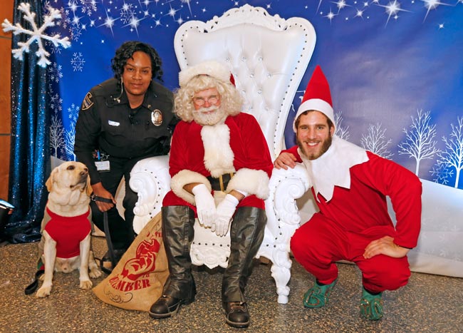 Cpl. Shaneithia Lewis and K-9 officer Jack, Santa and an elf at the 2019 Turkey Toss. (Steve Green/Vanderbilt)
