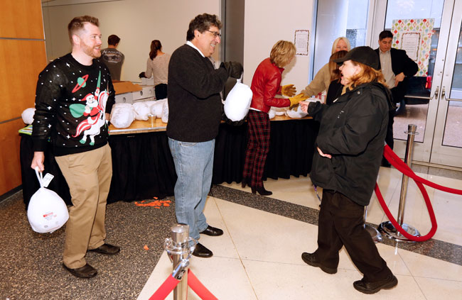 Vice Chancellor for Communications Steve Ertel and Chancellor Nicholas S. Zeppos hand out turkey at the annual Employee Appreciation event. (Steve Green/Vanderbilt)