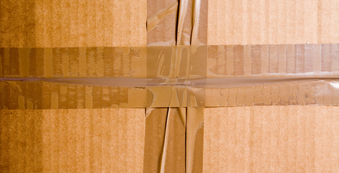 The side of a cardboard box with tape on it.