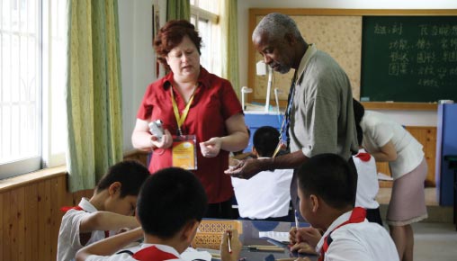 Laurie Smith, principal of Glenview Elementary School, and Julius Turnipseed, science teacher at the Nashville School of the Arts, observe a classroom during their June trip to Guangzhou, China.