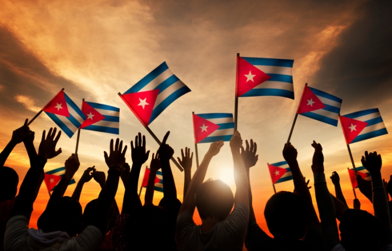 Silhouettes of People Holding Flag of Cuba