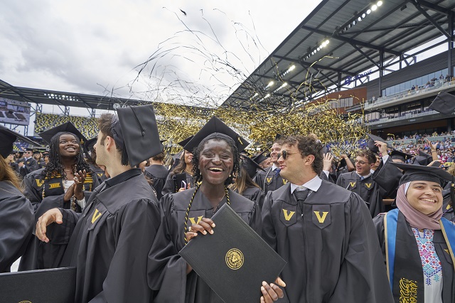 Image Description: Student holding diploma during 2024 Commencement.