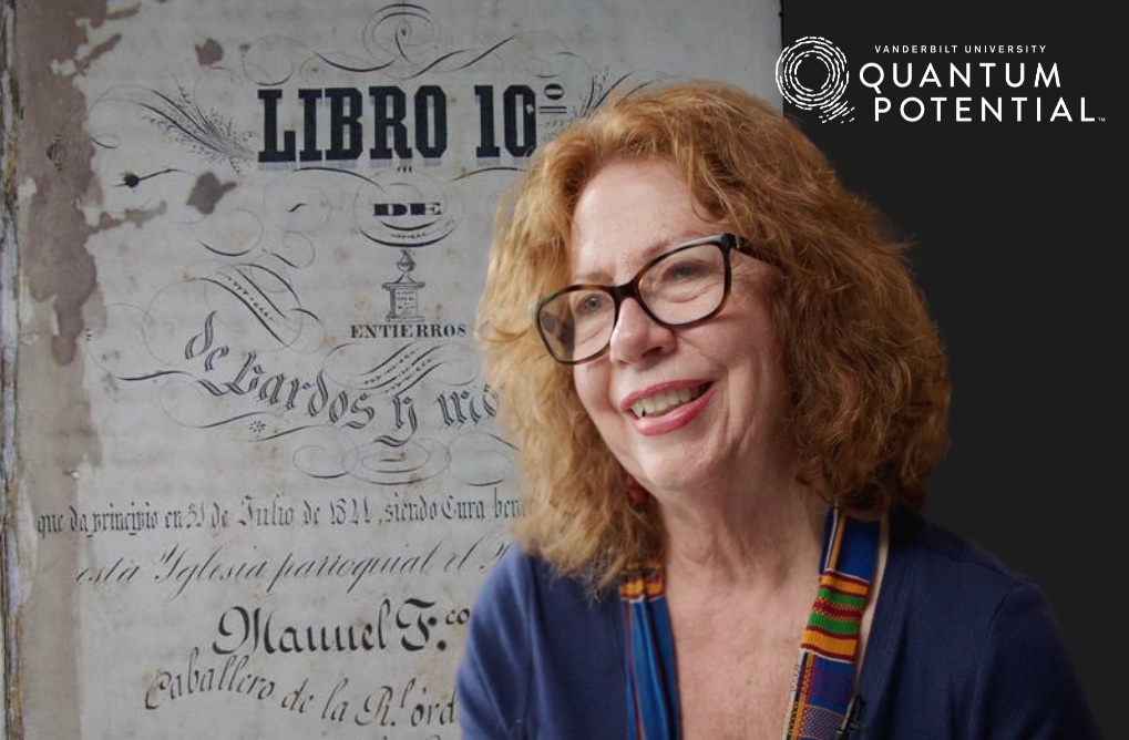 Jane Landers smiles while speaking to someone off-camera.
