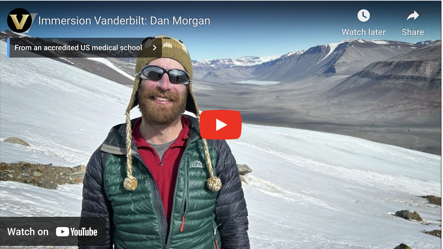 A video screen shot of a man standing on a snowy mountain.