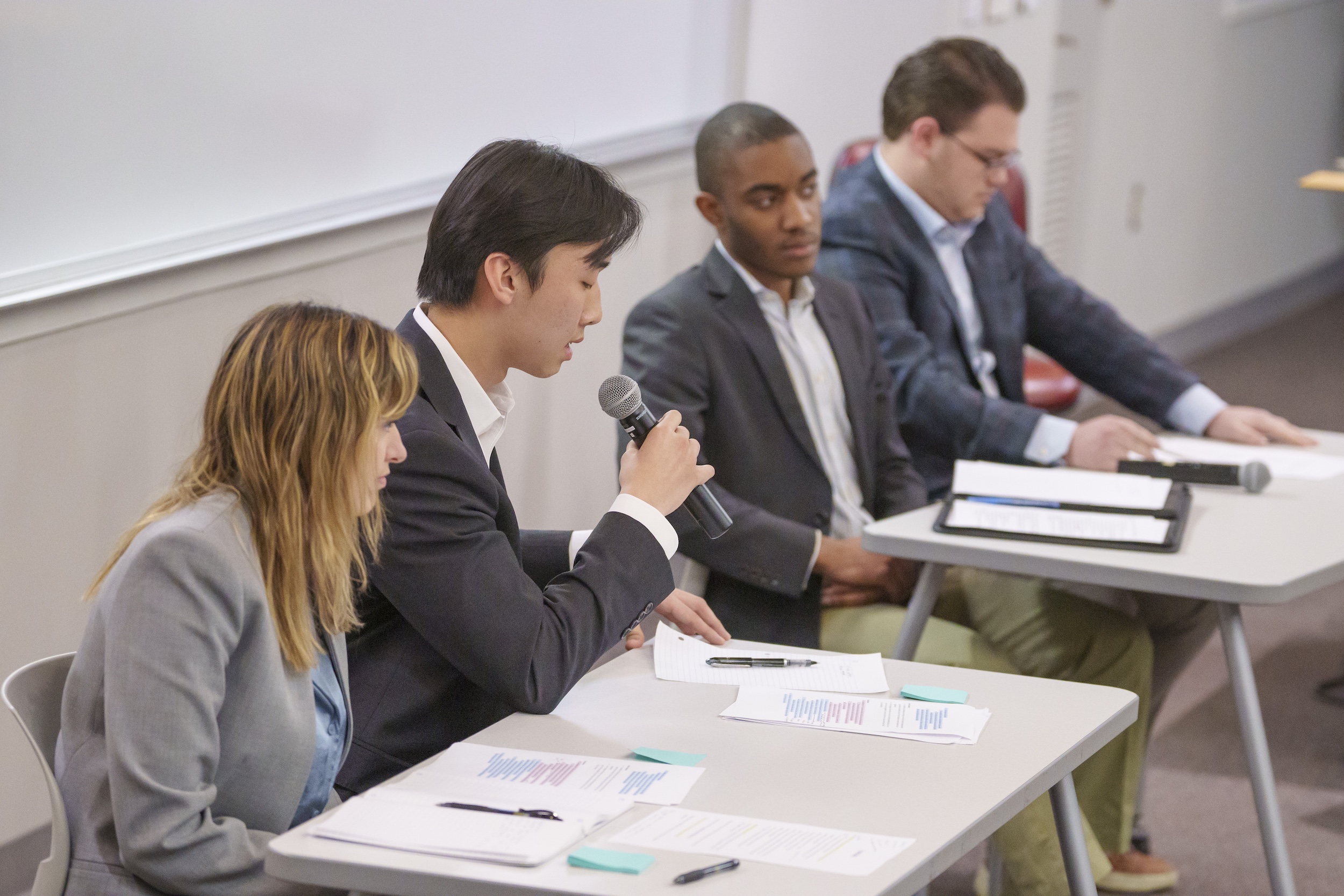 Four students sitting and participating in conversation