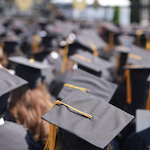 The top of students heads wearing their graduation caps