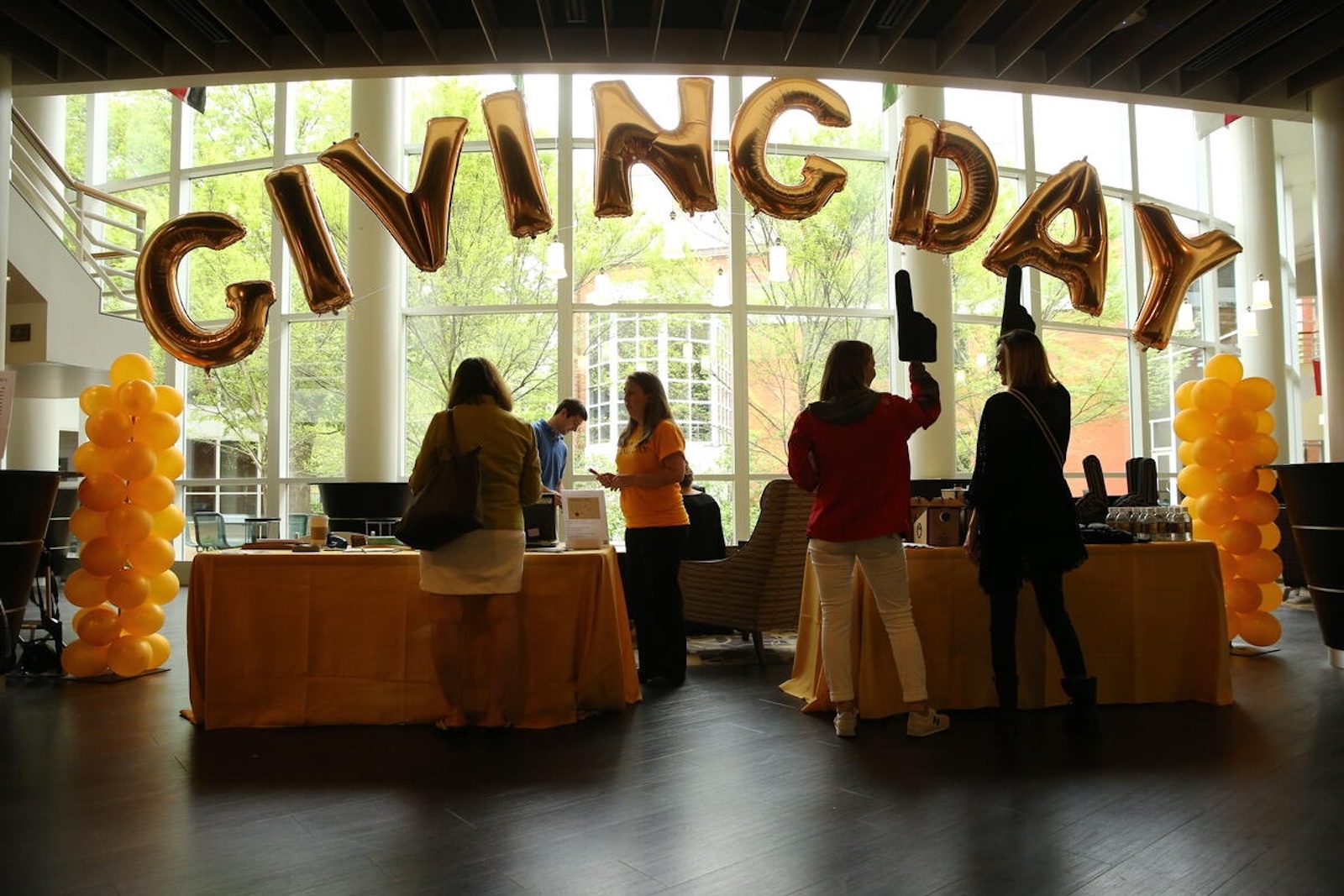 Balloons spell out "Giving Day" at a celebration on campus.