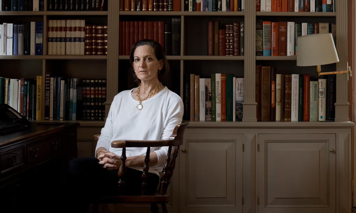 Anne Applebaum is pictured seated in her home library in Poland. 