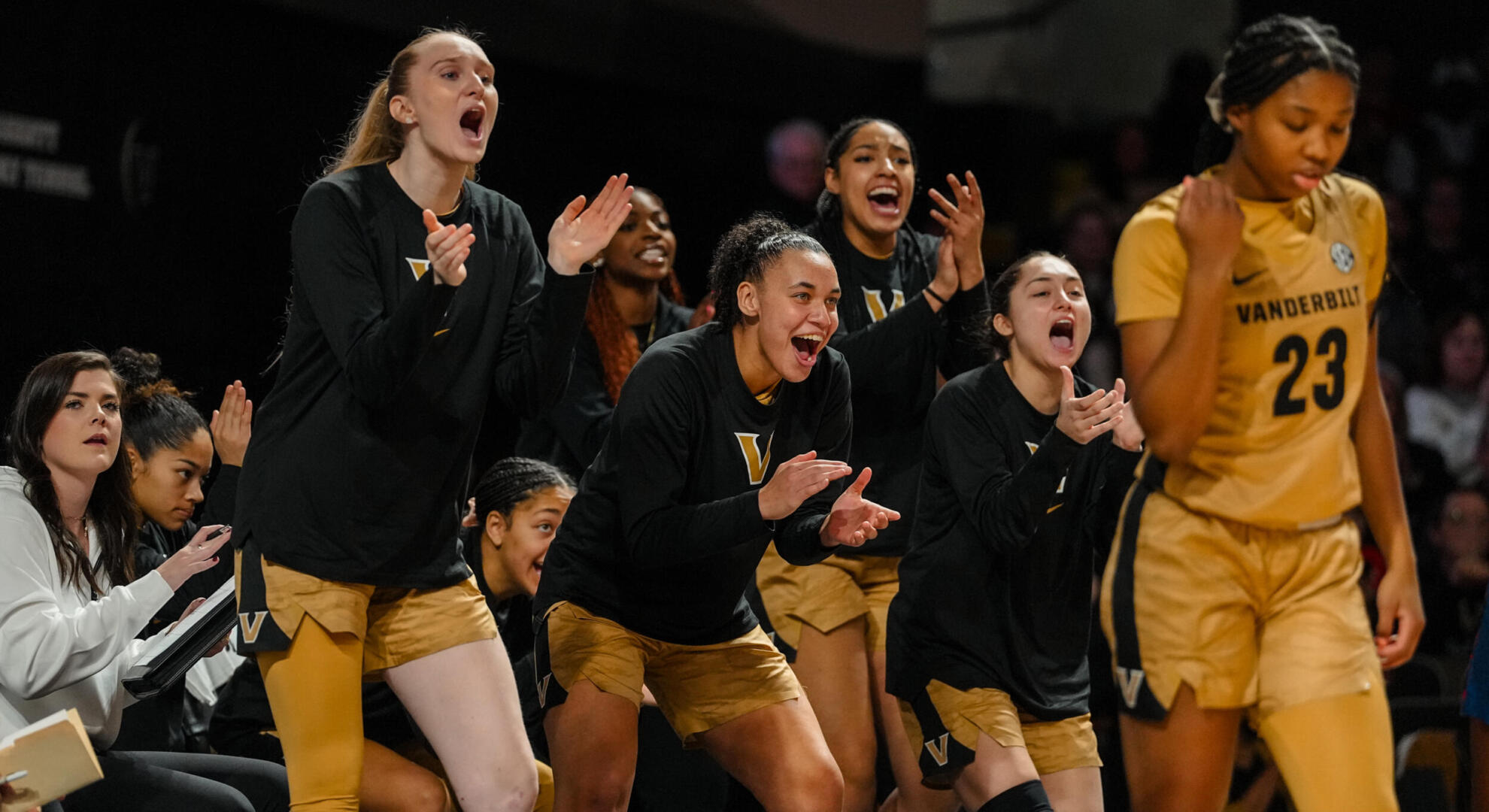 Vanderbilt women's basketball team members cheer on their teammates during a game.