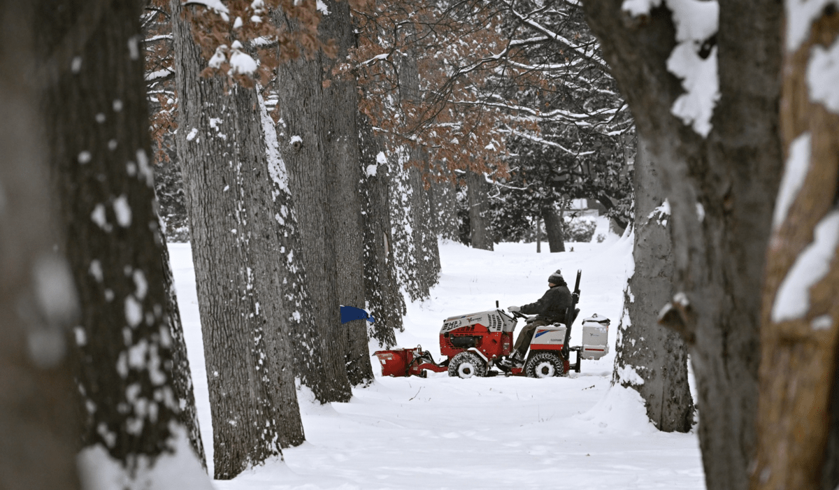 A Vanderbilt Grounds Team staff member plows snow on campus