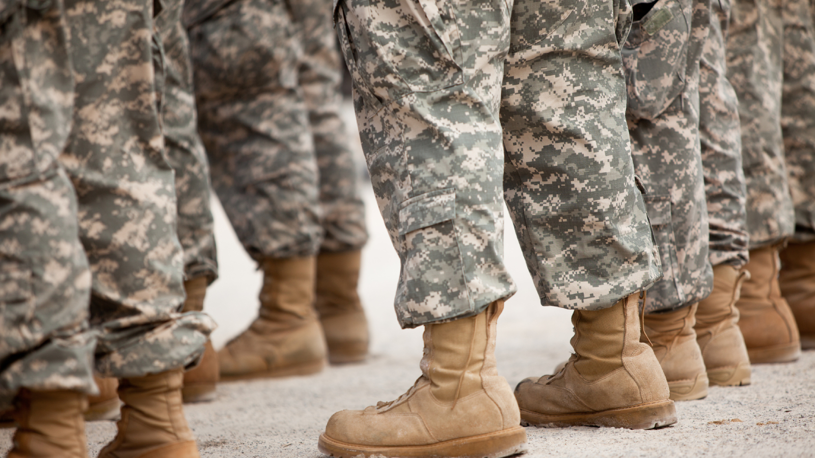 Uniformed service members are show from the knee down