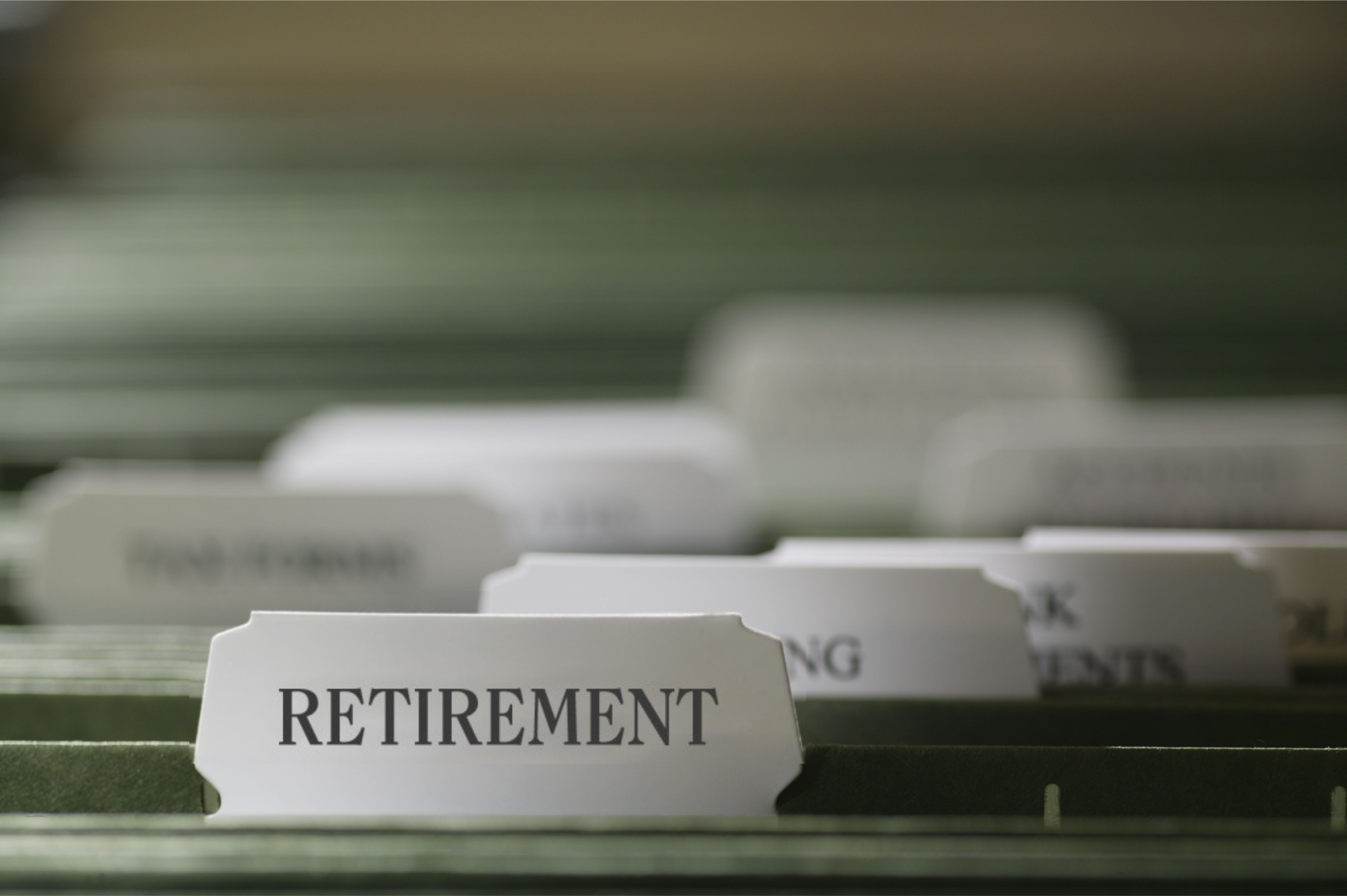 "Retirement" written on a file folder with other blurred folders behind