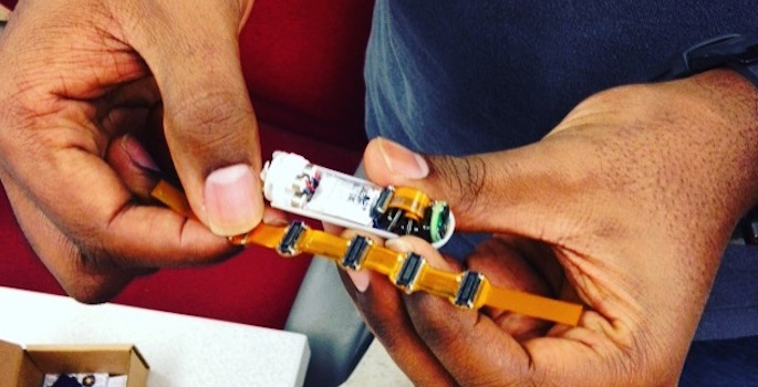 Closeup of tiny capsule in man's hands
