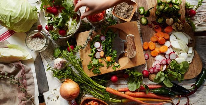 a table spread with a wide variety of furits and vegetables