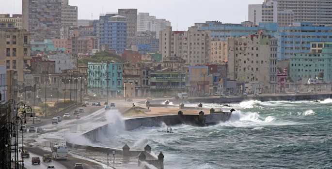 rough waves overtake seawall protecting caribbean city