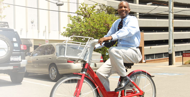 Community Neighborhood and Government Relations' David Mills takes one of the b-cycles for a spin. (Steve Green/Vanderbilt)