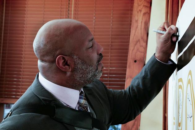 Jelani Cobb signs "The Zeppos Report" poster before his Jan. 17 lecture. (Vanderbilt University)