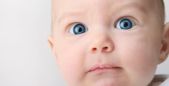 baby looking into the camera with uncertainty