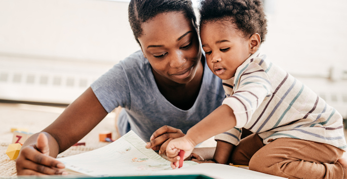 african american mother reading to son