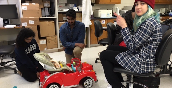 students working on car