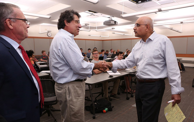School of Engineering Dean Philippe Fauchet, left, looks on as Chancellor Nicholas S. Zeppos, center, surprises Amrutur Anilkumar, professor of the practice of aerospace and mechanical engineering, with the 2017 Chancellor's Cup. (Anne Rayner/Vanderbilt)