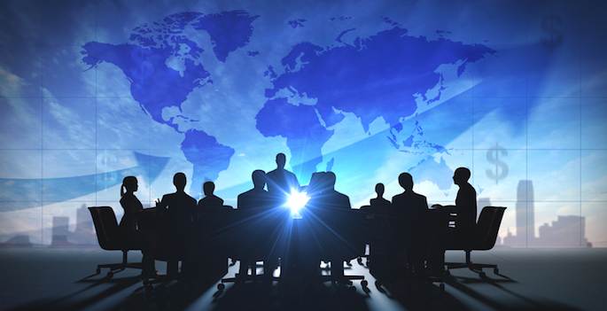 people in silhouette with a world map behind them