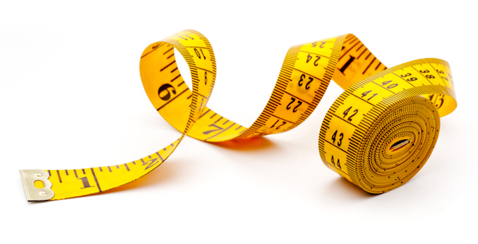 Yellow measuring tape, isolated on white background