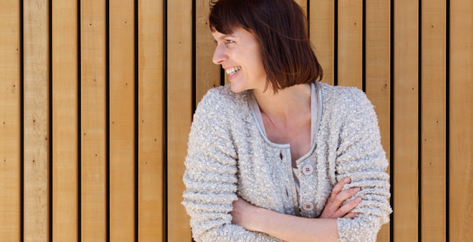 smiling woman with arms crossed
