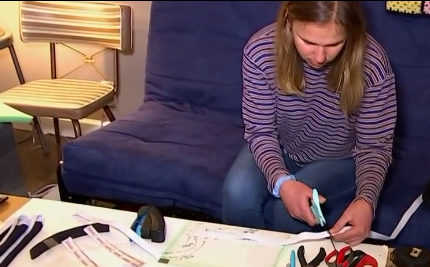 Katy Riojas, a mechanical engineering Ph.D. student, makes face shields in her home.