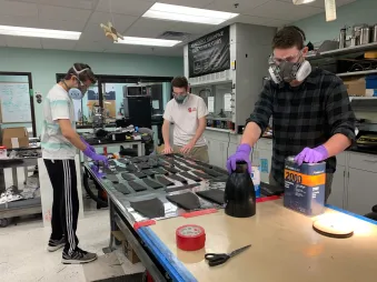 Building a carbon fiber nose cone with members of the rocket team.