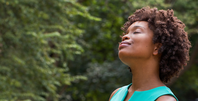 African American woman looks up at sky