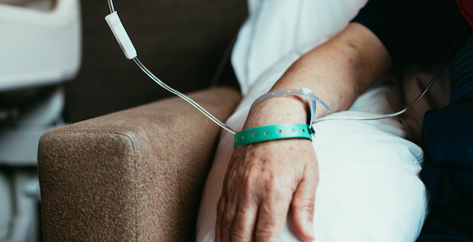 close up of mans arm as he receives chemotherapy infusion